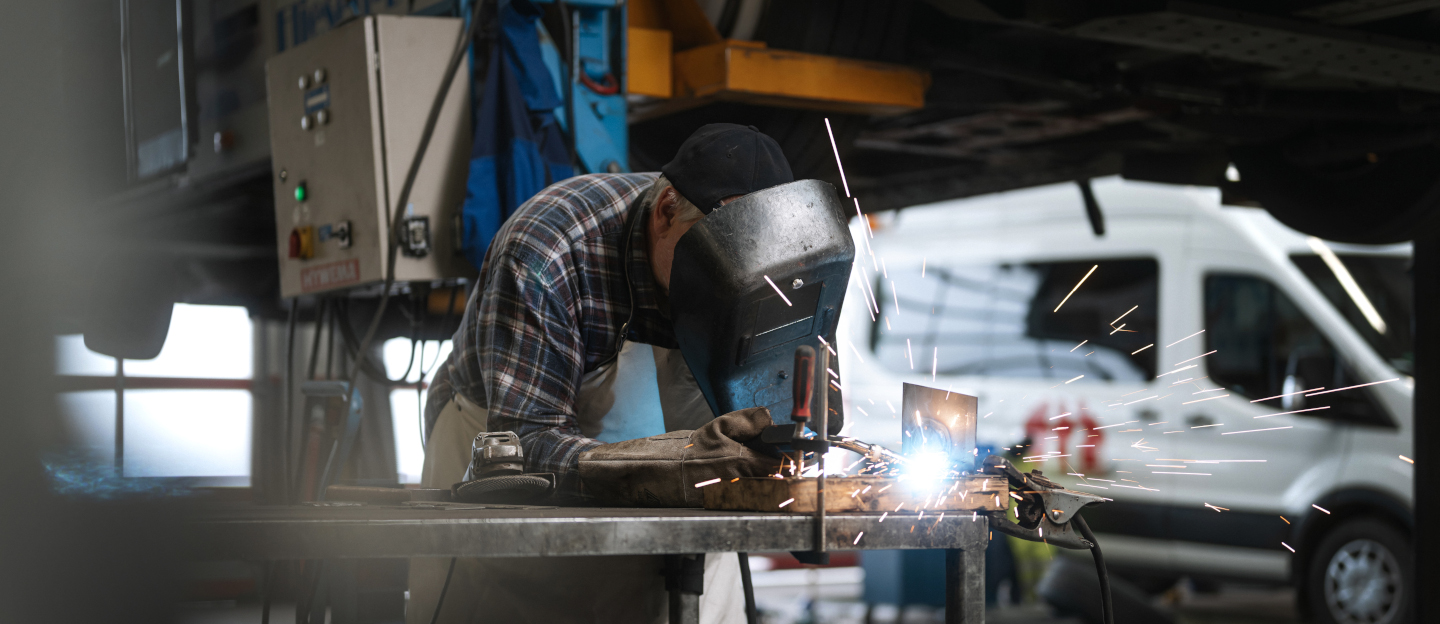 Ein Werkstattmitarbeiter schweisst, um etwas zu reparieren